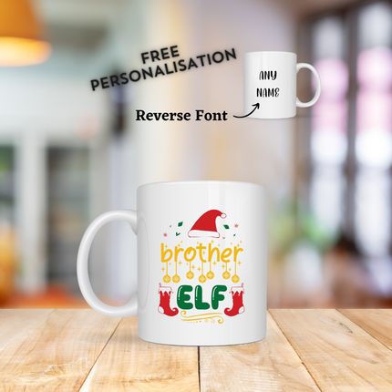 White mugs with Christmas-themed designs on a wooden surface. The mug says Brother Elf and has an option to customise with any name.