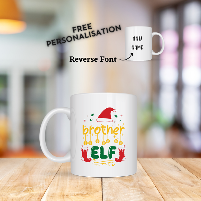 White mugs with Christmas-themed designs on a wooden surface. The mug says Brother Elf and has an option to customise with any name.